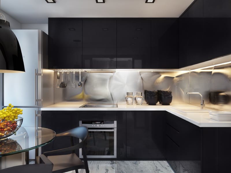 Black modular kitchen with steel backsplash